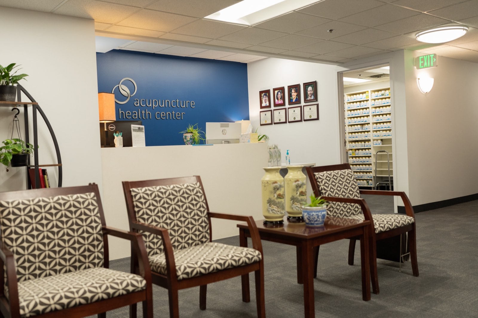 Seating area with the clinic's Chinese herbal pharmacy shelves in the background